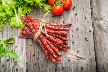 Food background. Snack stick sausages on a wooden table