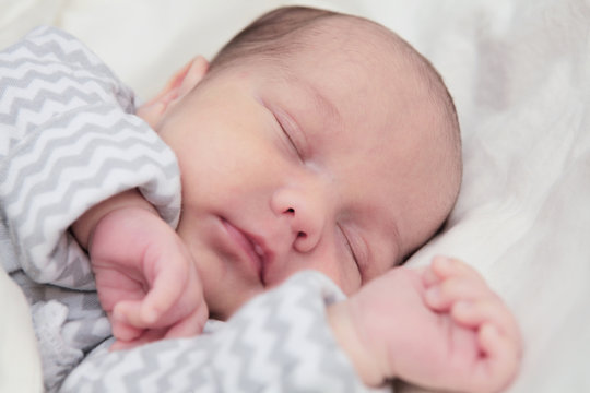 Cute newborn baby sleeping, face closeup