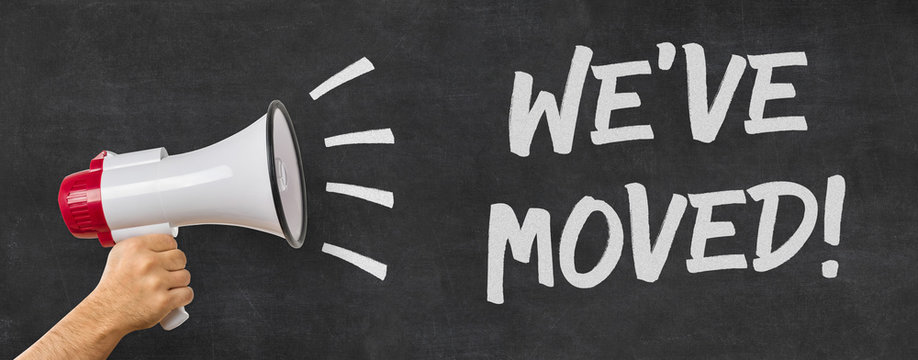 A man holding a megaphone - We have moved