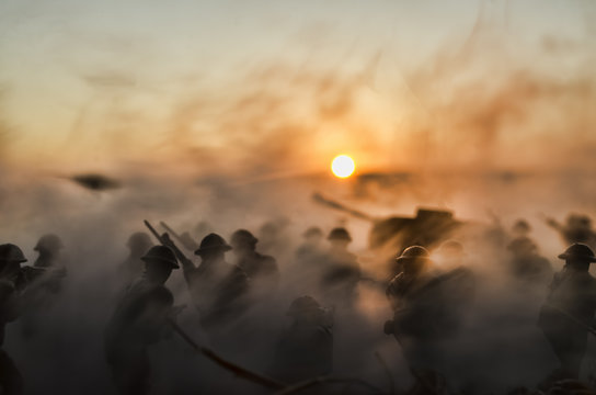 War Concept. Military silhouettes and tanks fighting scene on war fog sky background, World War Soldiers Silhouettes Below Cloudy Skyline At Dusk or Dawn. Attack scene
