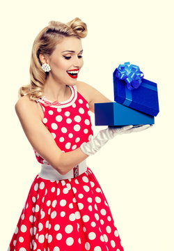 woman in pin-up style dress with gift box