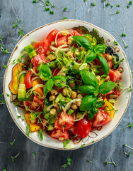 Chickpea salad with tomato, avocado, basil and olive oil