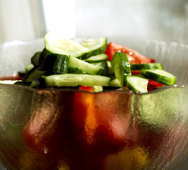 Sliced cucumbers and tomatoes in a bowl
