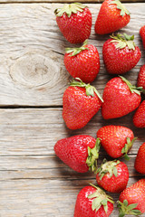 Fresh and tasty strawberries on a grey wooden table