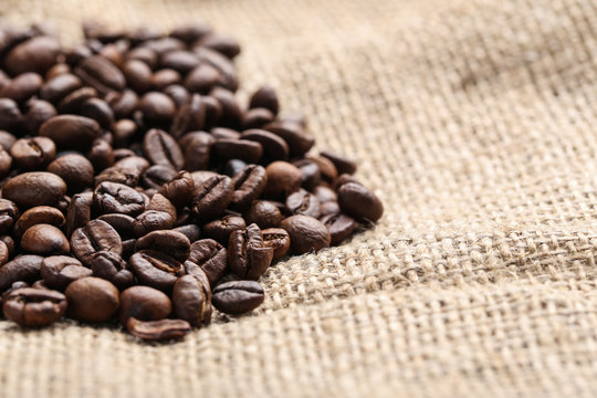 Brown roasted coffee beans on sackcloth