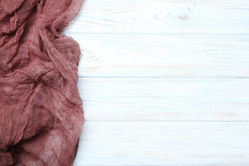 Burgundy gauze fabric on white wooden table