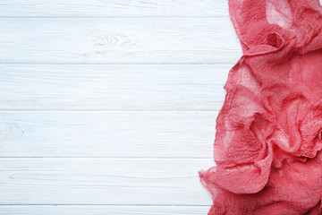 Red gauze fabric on white wooden table