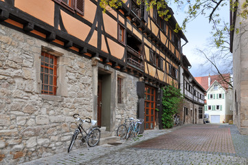 Old narrow street with half-timbered houses and bicycles. Tubingen, Baden-Wuerttemberg, Germany.