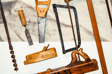 Old tools, saw, plane, drill, bits of iron and wood, vintage style