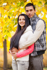 photo of cute couple hugging on the wonderful yellow trees background