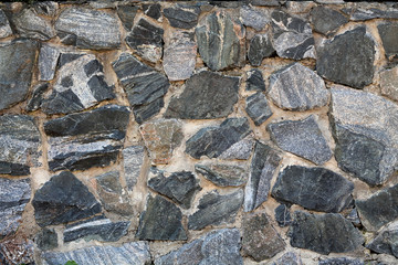 Masonry made of granite stone. Background.