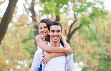 photo of cute couple hugging on the wonderful autumn park background