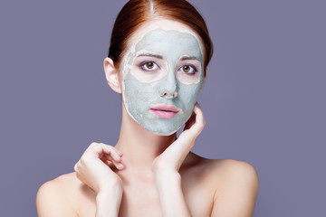 photo of beautiful young woman with mask on her face on the wonderful grey background