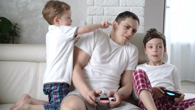 child tries to distract her young man from a video game.  Bright vivid emotions
