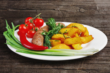 homemade sausage with fried potato, tomato cherry, pepper and green onion.