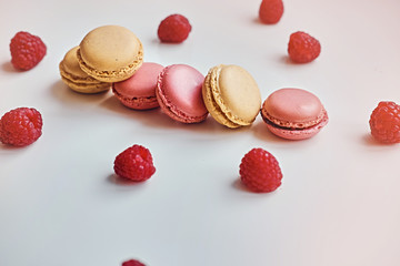 Delicious, colorful cookies and red raspberry on a table.