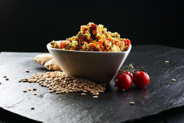 Lentil with carrot and pumpkin ragout in a wooden bowl on a wood