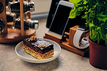 Sweet cake on a table with smart watch, tablet PC and smart phone.