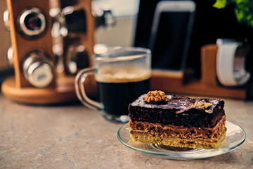 Sweet cake, cup of coffee on a table with smart watch, tablet PC and smart phone.