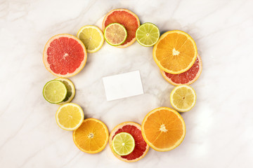 Vibrant citrus fruits with business card for copyspace