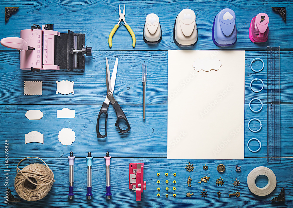 Wall mural top view of wooden table with tools for scrapbooking