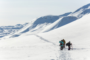 Fototapeta na wymiar Skiers walk on the frozen trail. Beautiful winter landscape with snow-topped mountains. Ski resort