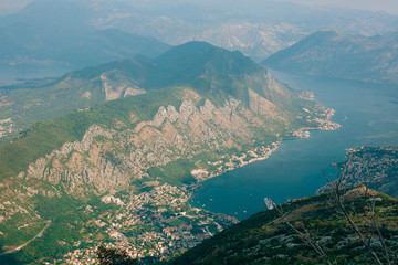 Bay of Kotor from the heights. View from Mount Lovcen to the bay. View down from the observation platform on the mountain Lovcen. Mountains and bay in Montenegro. The liner near the old town of Kotor.