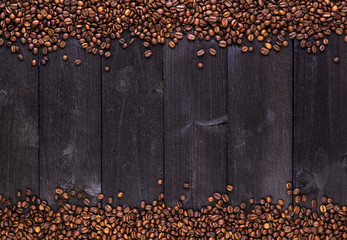 Frame of coffee beans on dark wooden background. Top view with copy space