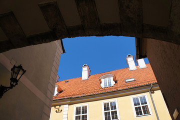 Yard in old Riga, Latvia town with ark and yellow house bottom view