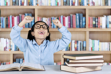 Elementary student celebrating her success in library