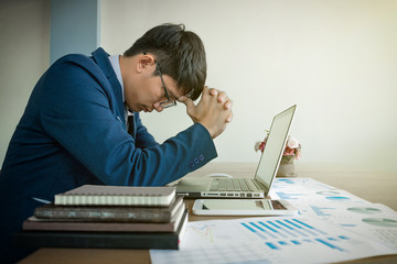 portrait of stressed business man with document graph in the office.