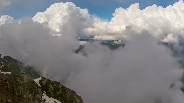Cableway in the mountains against the clouds sky 4K
