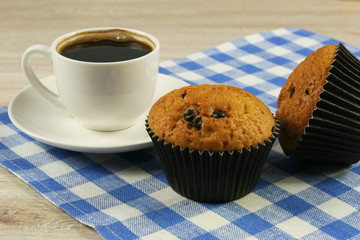 Chocolate muffins with a Cup of coffee on the table
