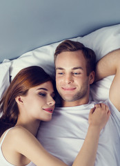 Happy young couple on the bed