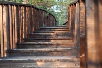 Fototapeta na wymiar The stairs to wooden bridge
