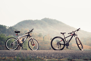 Fototapeta na wymiar Bicycle on mountain park road outdoor park, vintage color