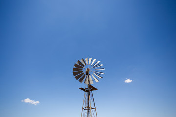 Close up wide angle image of a windmill / windpomp with static blades in the Tankwa Karoo in South Africa on a hot summersday