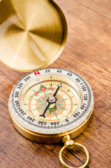 Vintage compass on wooden.