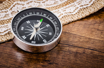 Vintage compass on wooden.