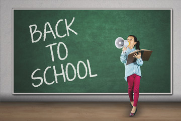 Student speaking on megaphone in classroom