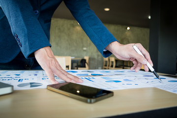 Close up of hand businessman working plan the business and analysis many chart graph. business concept.
