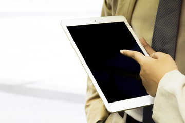 Tablet computer touch screen business people finger office desk. Modern people doing business, graphs and charts being demonstrated on the screen of a tablet. Modern Business Concept.