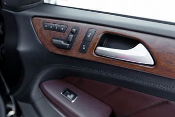 Fototapeta na wymiar Door panel with power window controller. Detail of the car interior
