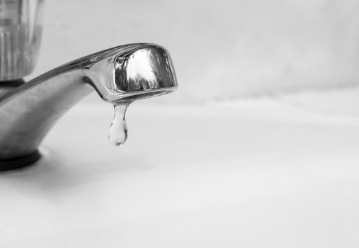 Closeup tap with water dropping, black and white color tone