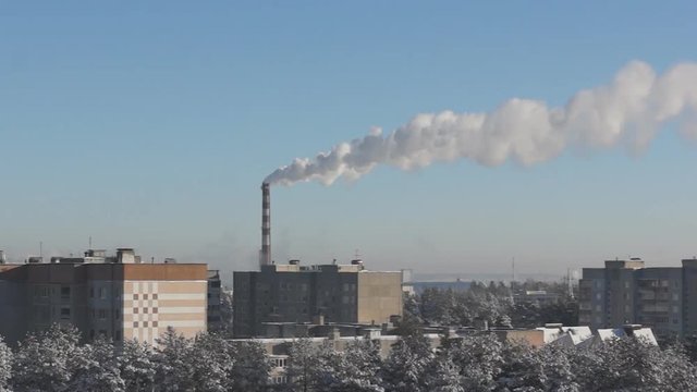 factory chimney fumes over the city