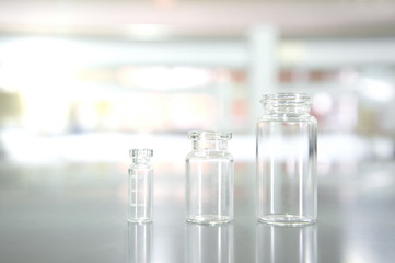 three clear vial or bottle in medical science laboratory