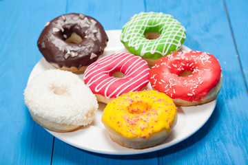 Doughnuts on blue wooden table