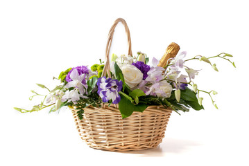 beautiful bouquet of bright wildflowers in basket, isolated on white