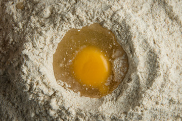 Top view of egg in flour