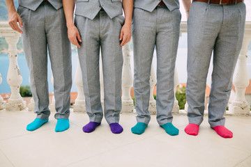Men in colorful socks. Funny wedding photos. Wedding in Montenegro.